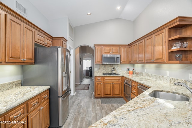 38459 S Bellrock Ct, Tucson, AZ 85739 - kitchen with a sink, stainless steel appliances, arched walkways, light stone countertops, and high vaulted ceiling