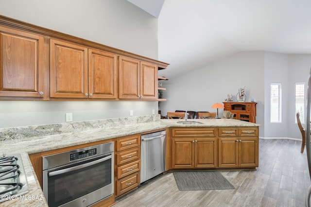 38459 S Bellrock Ct, Tucson, AZ 85739 - kitchen with stainless steel appliances, lofted ceiling, a peninsula, light wood-style floors, and a sink