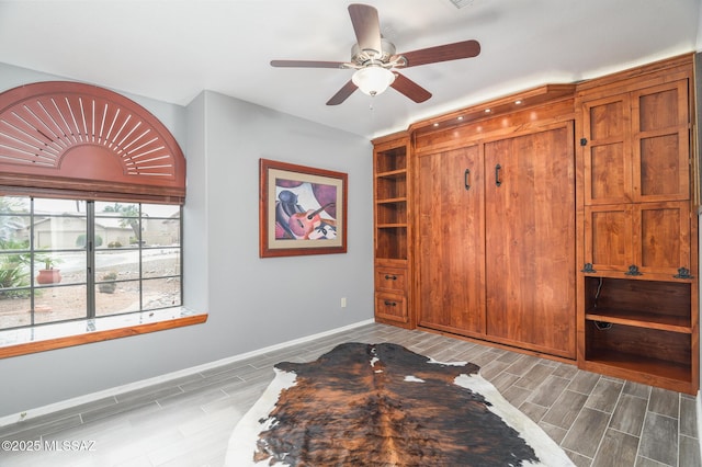 38459 S Bellrock Ct, Tucson, AZ 85739 - bedroom featuring wood tiled floors, baseboards, and ceiling fan