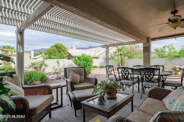 38459 S Bellrock Ct, Tucson, AZ 85739 - view of patio / terrace featuring outdoor dining space, a ceiling fan, a fenced backyard, and a mountain view