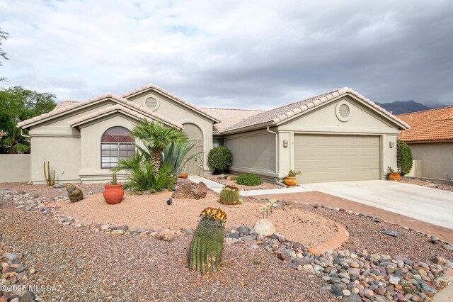 38459 S Bellrock Ct, Tucson, AZ 85739 - ranch-style house featuring a tile roof, stucco siding, driveway, and an attached garage