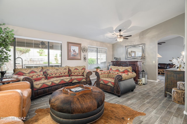38459 S Bellrock Ct, Tucson, AZ 85739 - living room featuring a ceiling fan, wood finish floors, baseboards, and arched walkways