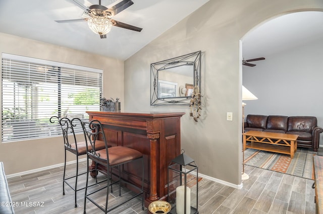 38459 S Bellrock Ct, Tucson, AZ 85739 - bar with ceiling fan, arched walkways, wood finished floors, vaulted ceiling, and baseboards