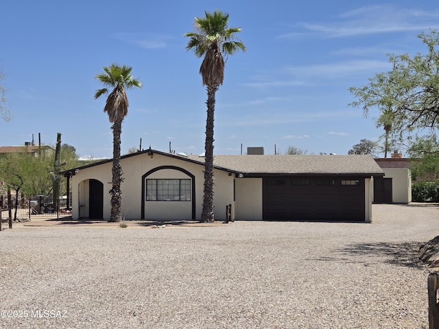 895 W Roller Coaster Rd, Tucson, AZ 85704 - view of front of home with gravel driveway, an attached garage, and stucco siding
