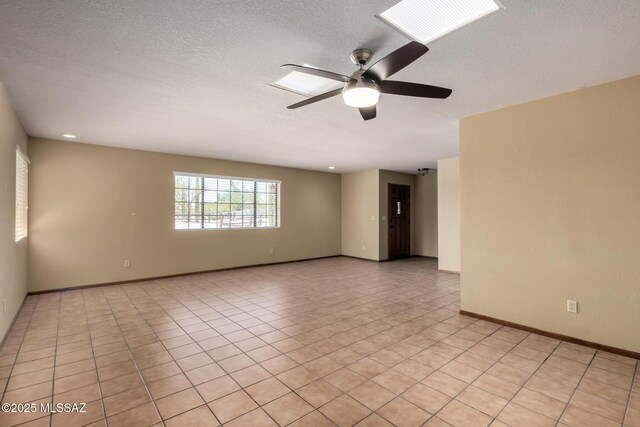 895 W Roller Coaster Rd, Tucson, AZ 85704 - empty room featuring ceiling fan, light tile patterned floors, and a textured ceiling