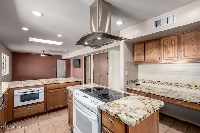 895 W Roller Coaster Rd, Tucson, AZ 85704 - kitchen featuring island range hood, white appliances, brown cabinets, decorative backsplash, and light tile patterned flooring