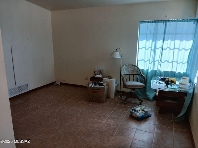 living area with tile patterned flooring and visible vents