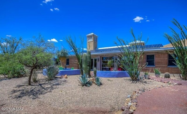 view of front of house featuring roof mounted solar panels