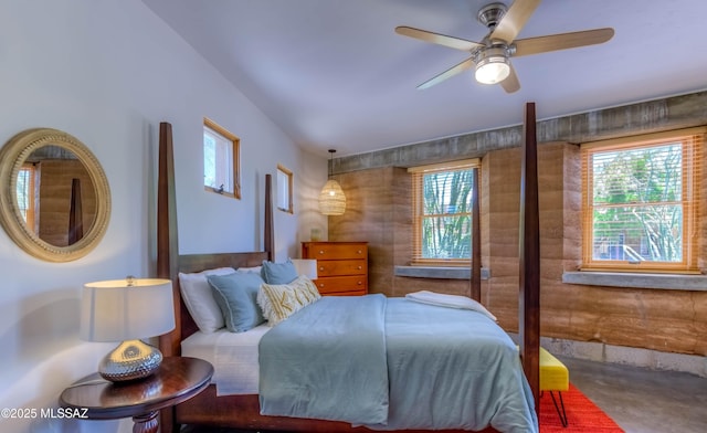 bedroom with a ceiling fan and concrete floors