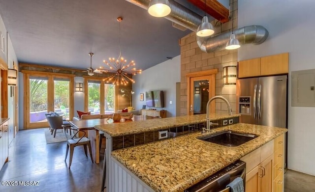 kitchen with a sink, open floor plan, concrete floors, a kitchen island with sink, and appliances with stainless steel finishes