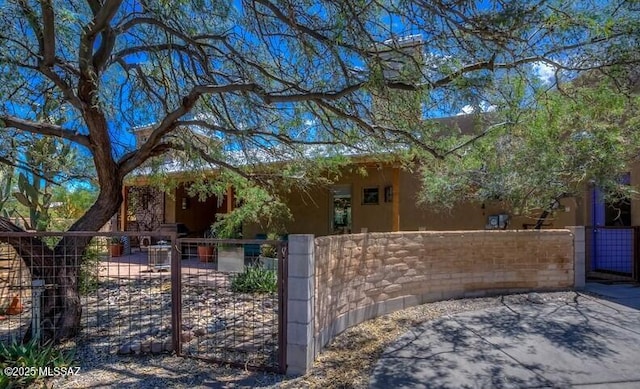 view of gate with a fenced front yard
