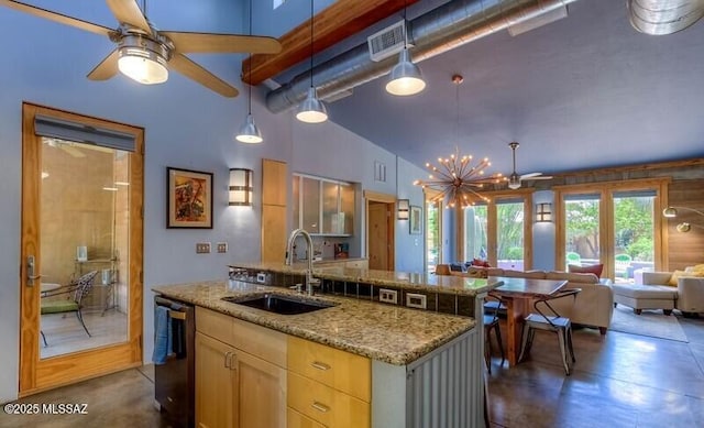 kitchen with a sink, ceiling fan with notable chandelier, dishwashing machine, open floor plan, and concrete floors