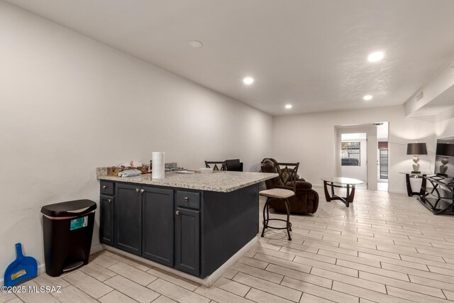 bar featuring light wood-style floors and recessed lighting