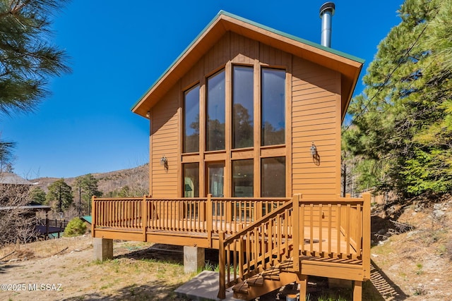 back of house with a deck with mountain view