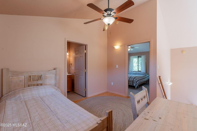 bedroom with ceiling fan, light wood finished floors, baseboards, and a high ceiling