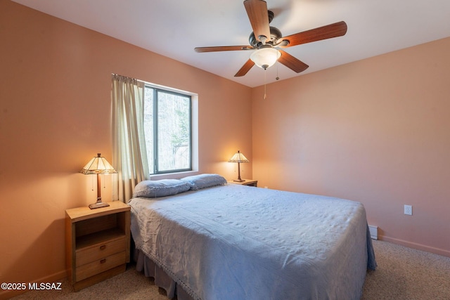 carpeted bedroom featuring baseboards and a ceiling fan