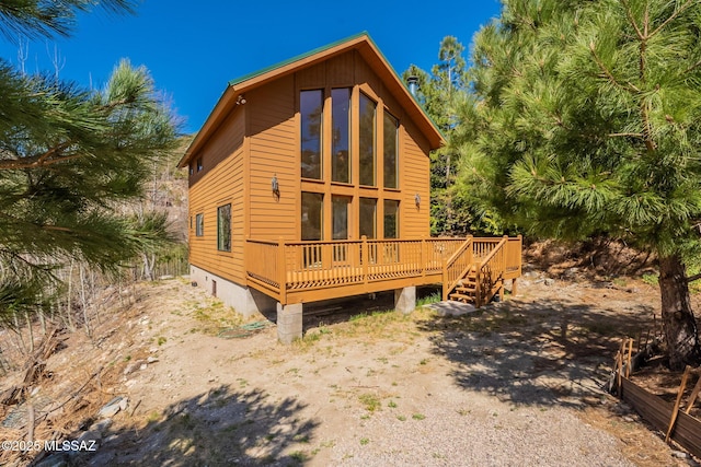 rear view of property with a wooden deck