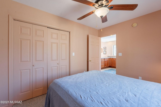 bedroom with a ceiling fan, a closet, and light colored carpet