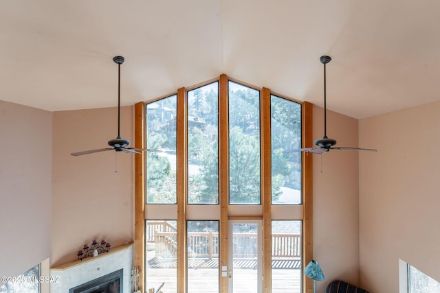 room details with a ceiling fan and a glass covered fireplace