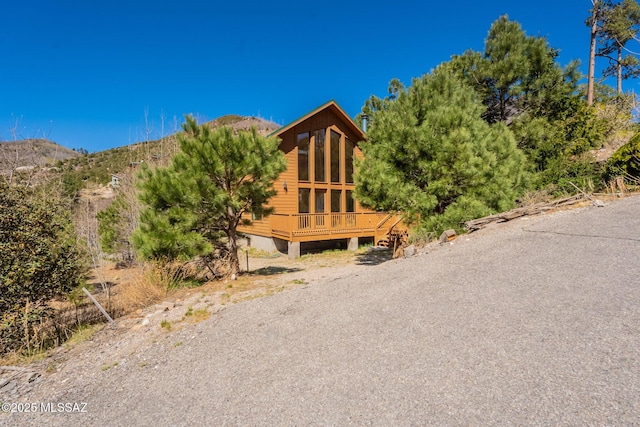 view of front facade featuring a deck with mountain view