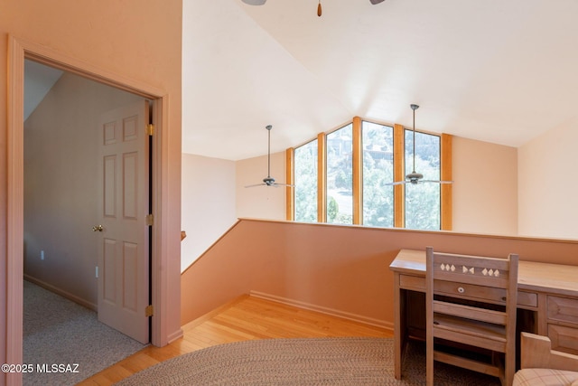 unfurnished bedroom with baseboards, vaulted ceiling, and wood finished floors