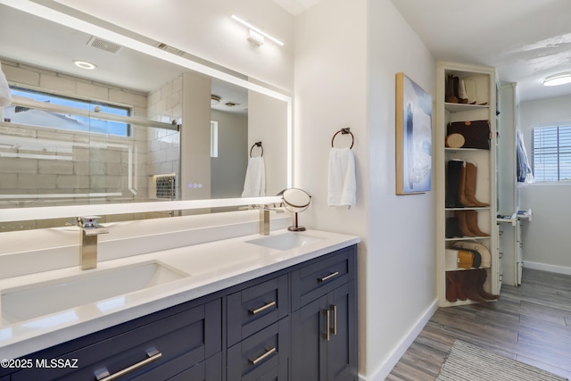 29 W Camino Rancho Viejo, Sahuarita, AZ 85629 - full bath featuring a shower stall, wood finished floors, baseboards, and double vanity