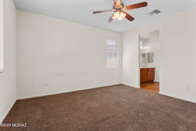 11413 E Squash Blossom Loop, Tucson, AZ 85747 - unfurnished bedroom featuring carpet floors, baseboards, ensuite bath, and ceiling fan