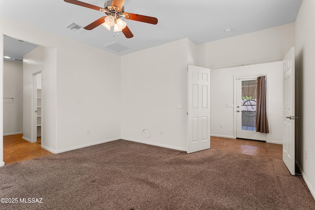 11413 E Squash Blossom Loop, Tucson, AZ 85747 - unfurnished bedroom featuring carpet flooring, baseboards, a ceiling fan, and tile patterned floors
