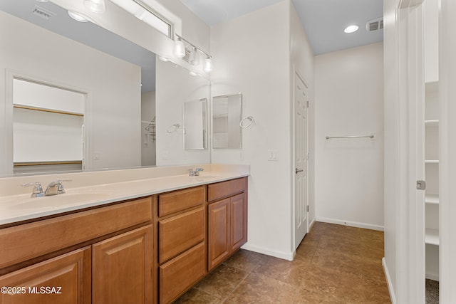 11413 E Squash Blossom Loop, Tucson, AZ 85747 - full bathroom featuring double vanity, a spacious closet, and baseboards