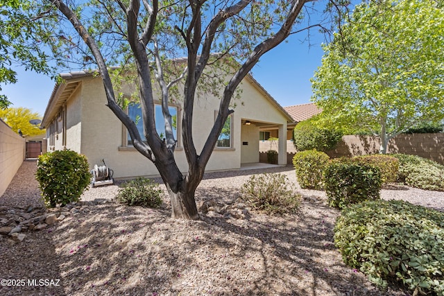 11413 E Squash Blossom Loop, Tucson, AZ 85747 - view of front of house featuring stucco siding, a fenced backyard, and a patio