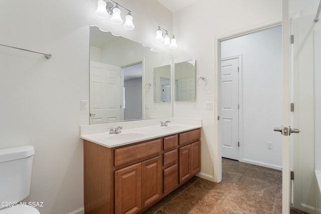 11413 E Squash Blossom Loop, Tucson, AZ 85747 - bathroom with toilet, double vanity, and baseboards