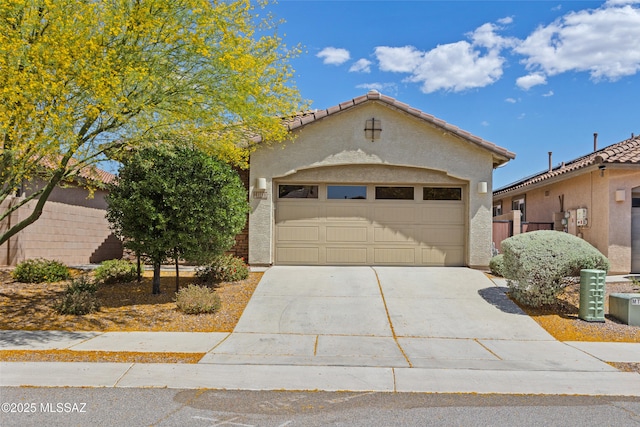 11413 E Squash Blossom Loop, Tucson, AZ 85747 - view of front of home with driveway, a garage, and stucco siding