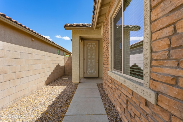 11413 E Squash Blossom Loop, Tucson, AZ 85747 - entrance to property with fence, a tile roof, and stucco siding