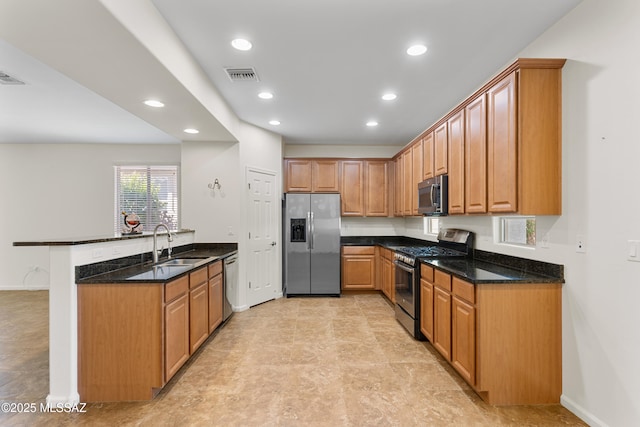 11413 E Squash Blossom Loop, Tucson, AZ 85747 - kitchen featuring stainless steel appliances, a sink, a peninsula, recessed lighting, and dark stone countertops