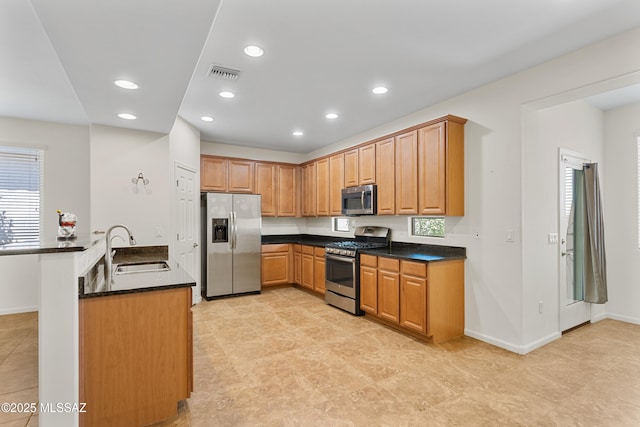 11413 E Squash Blossom Loop, Tucson, AZ 85747 - kitchen with appliances with stainless steel finishes, a sink, baseboards, recessed lighting, and dark stone countertops