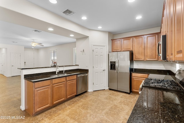11413 E Squash Blossom Loop, Tucson, AZ 85747 - kitchen with appliances with stainless steel finishes, a sink, a peninsula, brown cabinetry, and recessed lighting