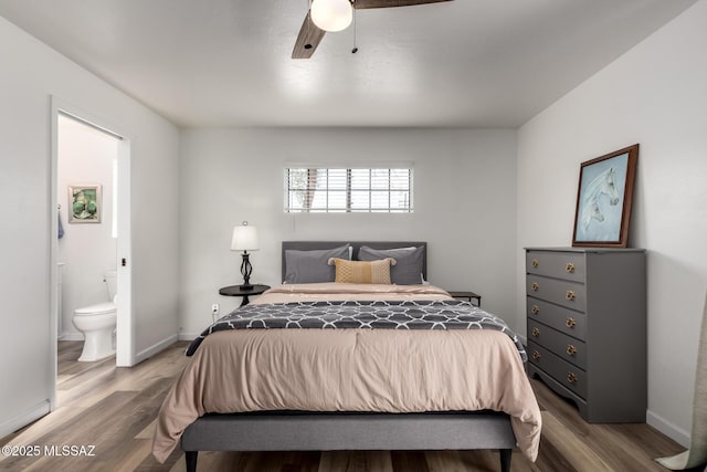 bedroom with ensuite bath, baseboards, and light wood-style floors