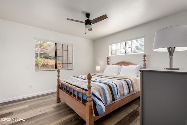 bedroom featuring baseboards, ceiling fan, and wood finished floors