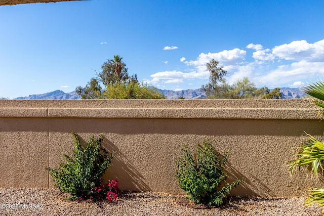 view of side of property featuring stucco siding and a mountain view