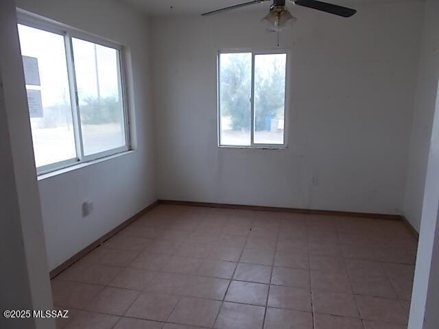 2491 N Joe Hines Rd, Willcox, AZ 85643 - spare room with a ceiling fan, light tile patterned flooring, and baseboards