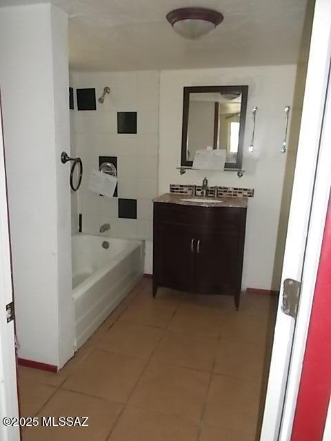 2491 N Joe Hines Rd, Willcox, AZ 85643 - bathroom featuring tile patterned flooring, vanity, and tub / shower combination