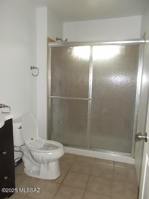 2491 N Joe Hines Rd, Willcox, AZ 85643 - full bathroom with tile patterned floors, toilet, a shower with door, and vanity