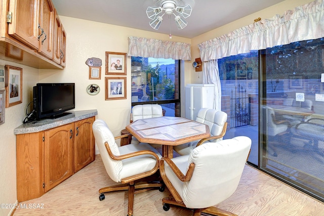 dining room with a ceiling fan and light wood-style floors