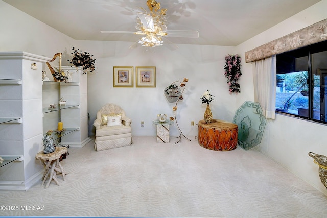 sitting room with carpet flooring and a ceiling fan