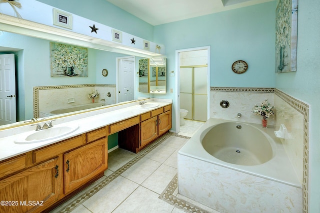 full bath with a sink, toilet, a bath, and tile patterned floors