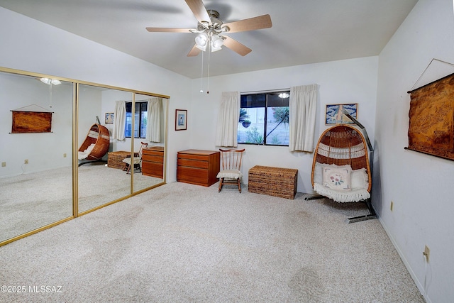 carpeted bedroom with a closet, baseboards, and ceiling fan