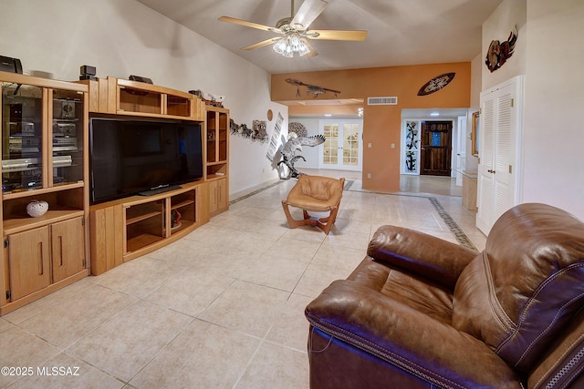 living room featuring a ceiling fan, baseboards, light tile patterned floors, and visible vents
