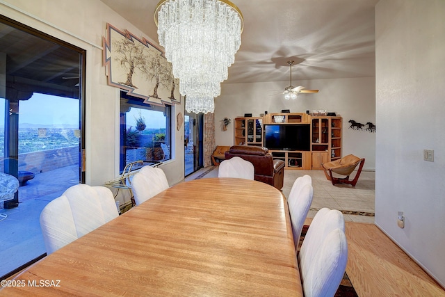 dining room with ceiling fan with notable chandelier