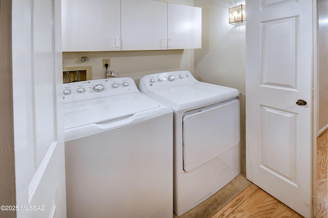 washroom featuring cabinet space and washer and dryer