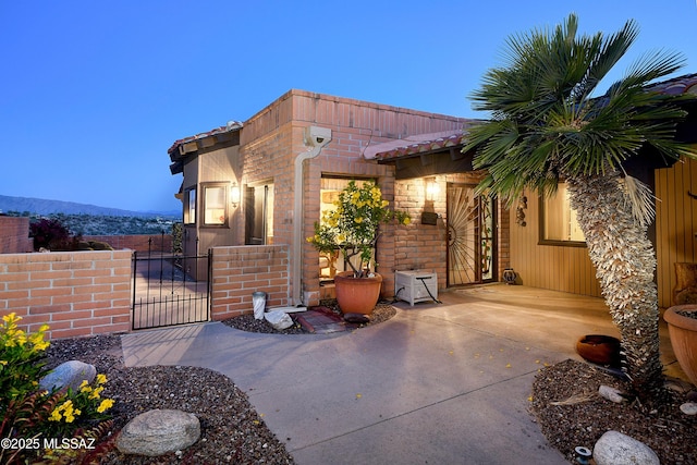 exterior space featuring fence and a gate